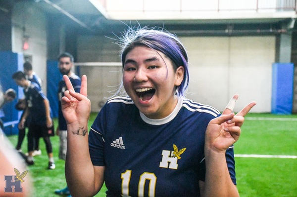 Rachel Chow smiling and throwing up the Peace sign