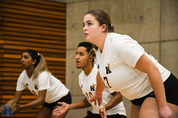 Shania getting ready to receive a serve in volleyball