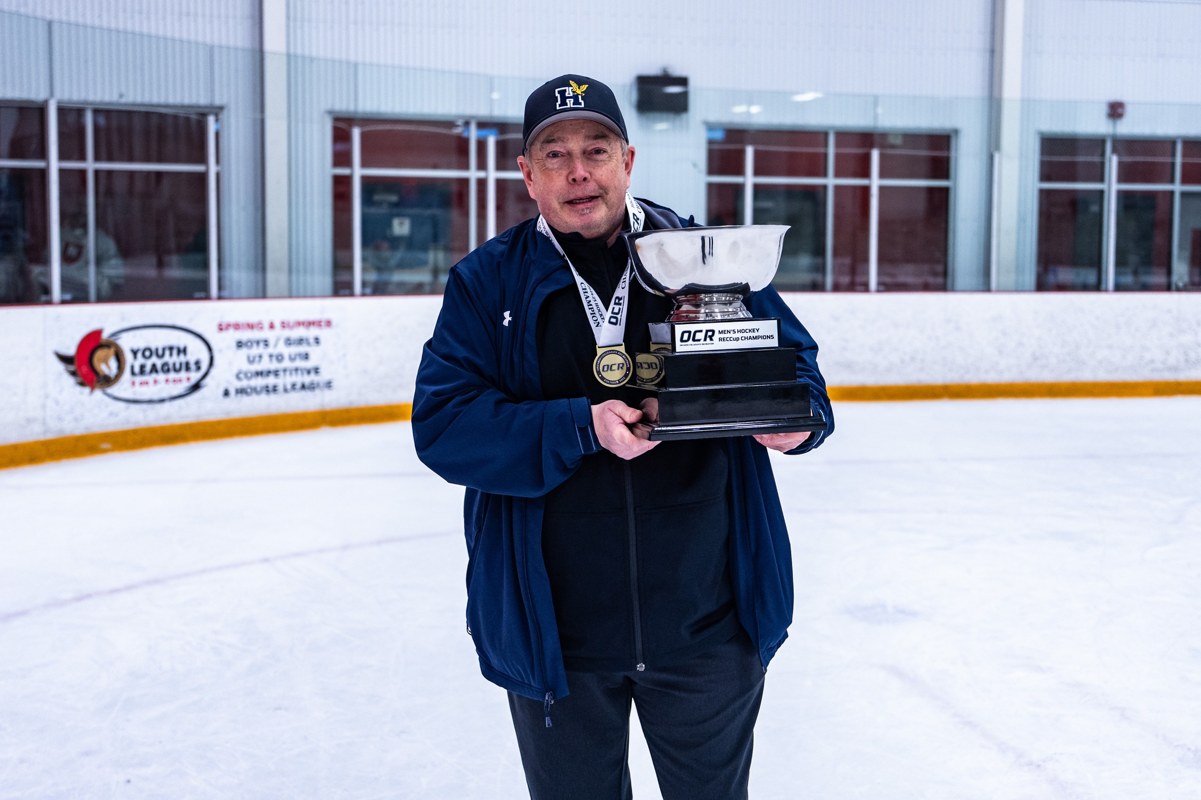Coach Dave holding a trophy
