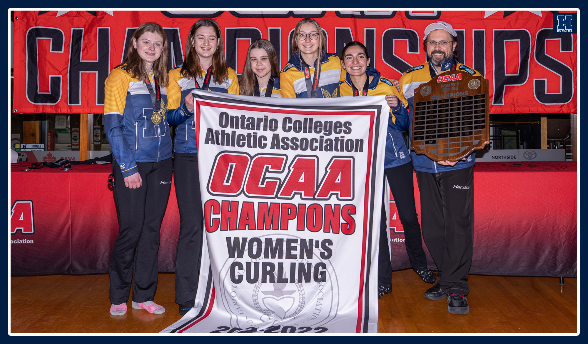 Women's squad posing with championship banner