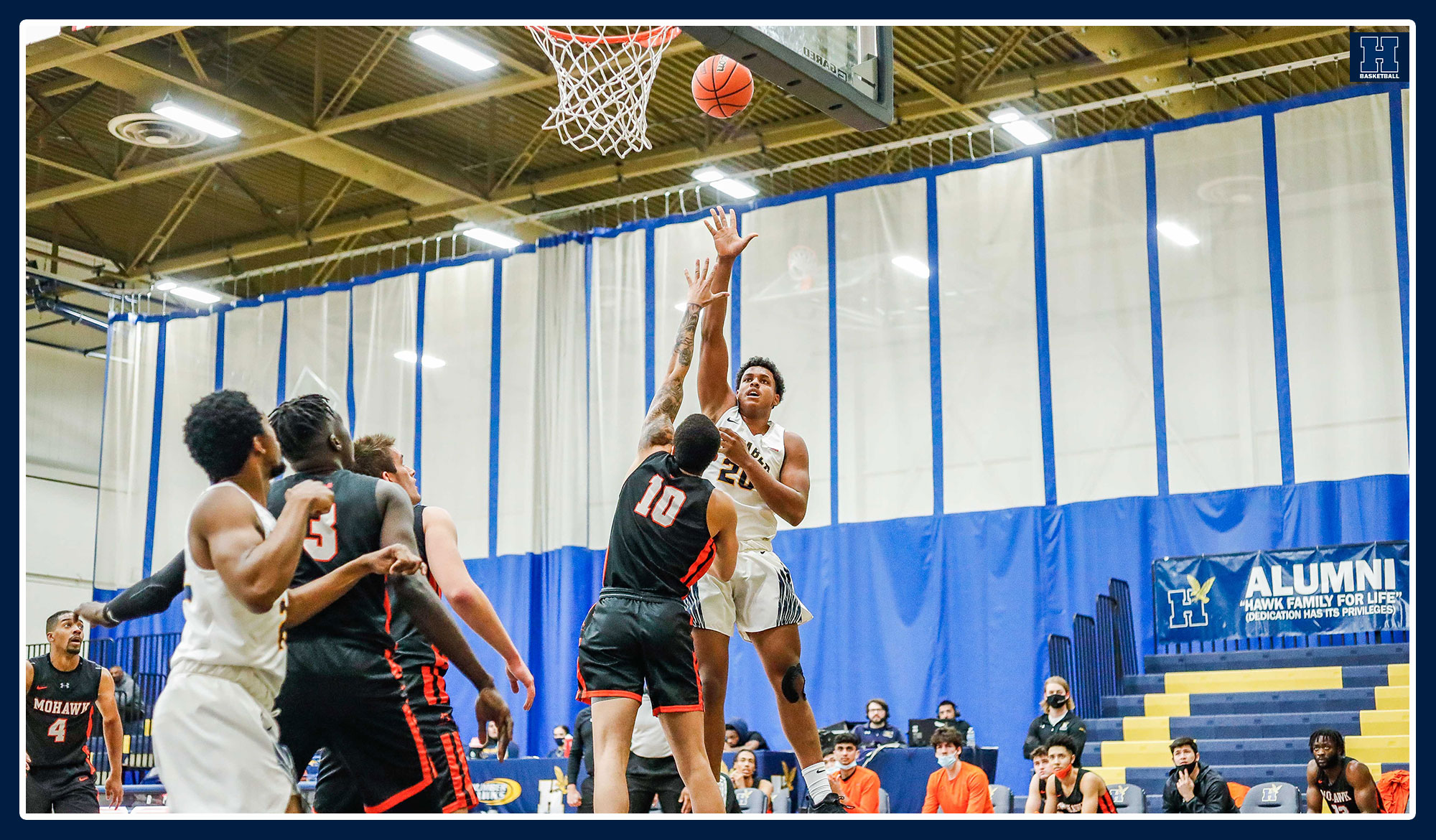 Mitchell shoots a floater over a Mohawk defender.