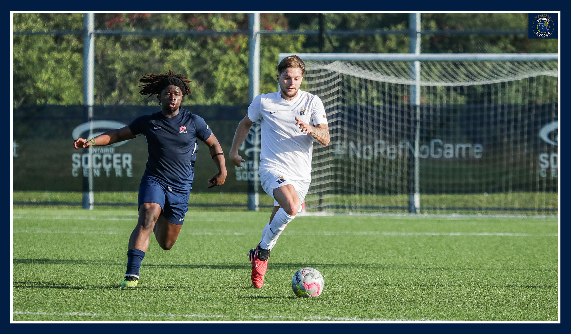 Alex Laic running past a defender
