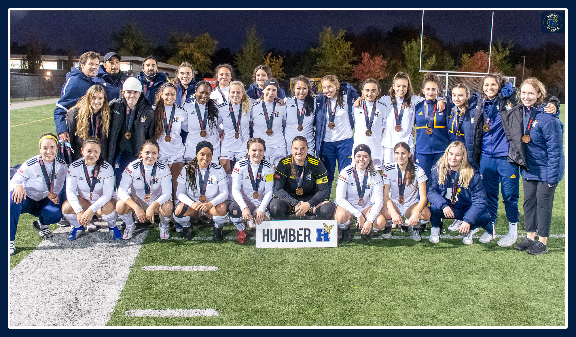 Women's soccer team photo wearing bronze medals