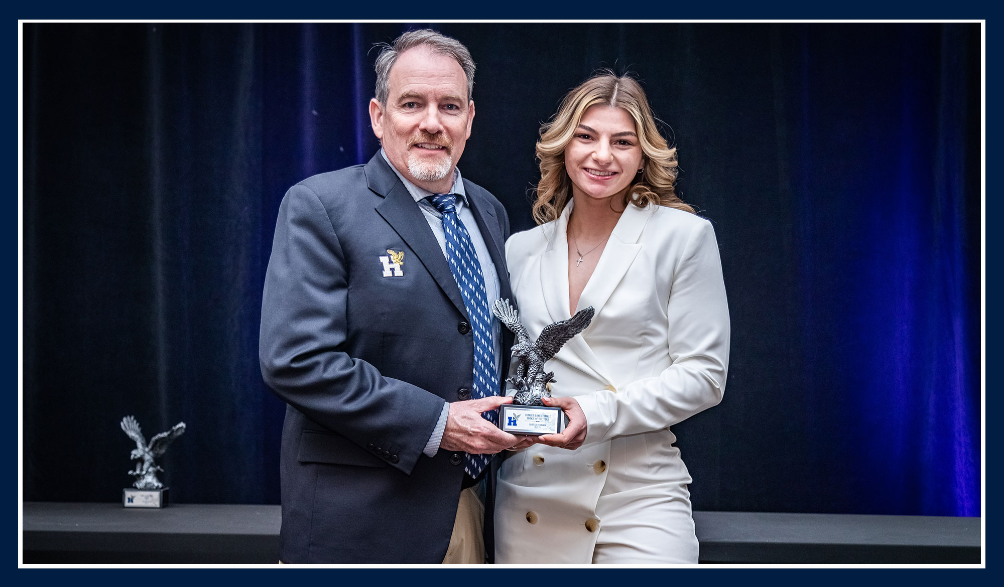 Isabella receiving her award from Ray Chateau