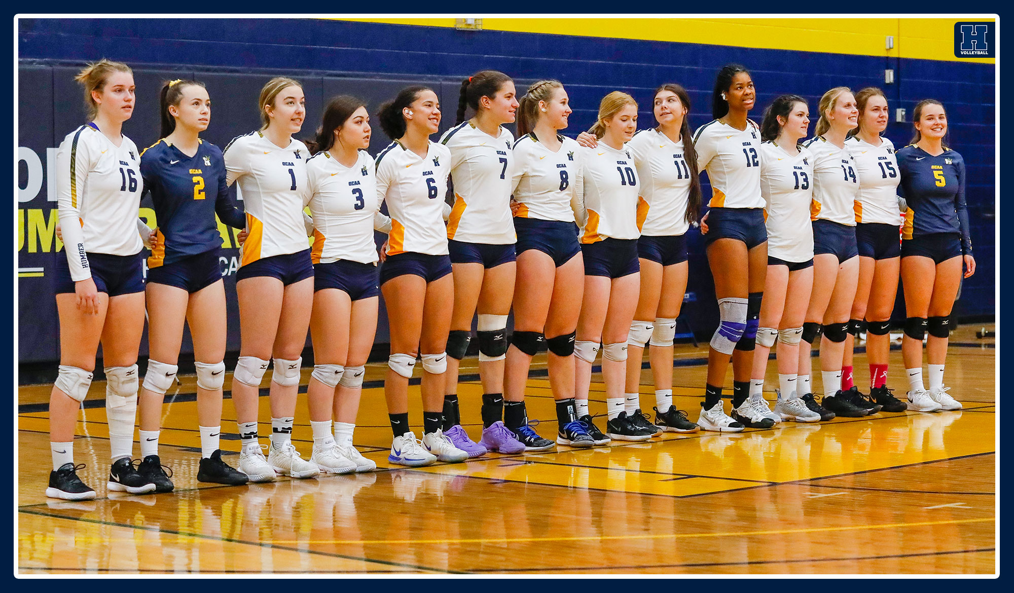 Women's volleyball stands for pre-game ceremonies