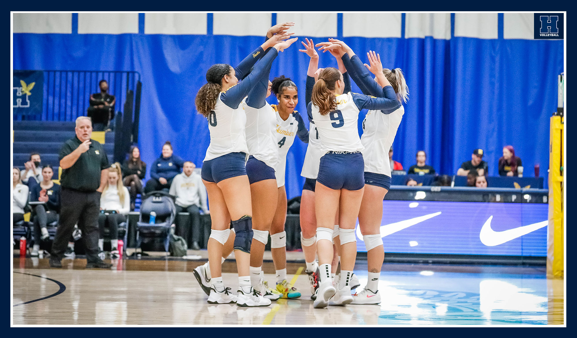 Women's volleyball celebrating a point