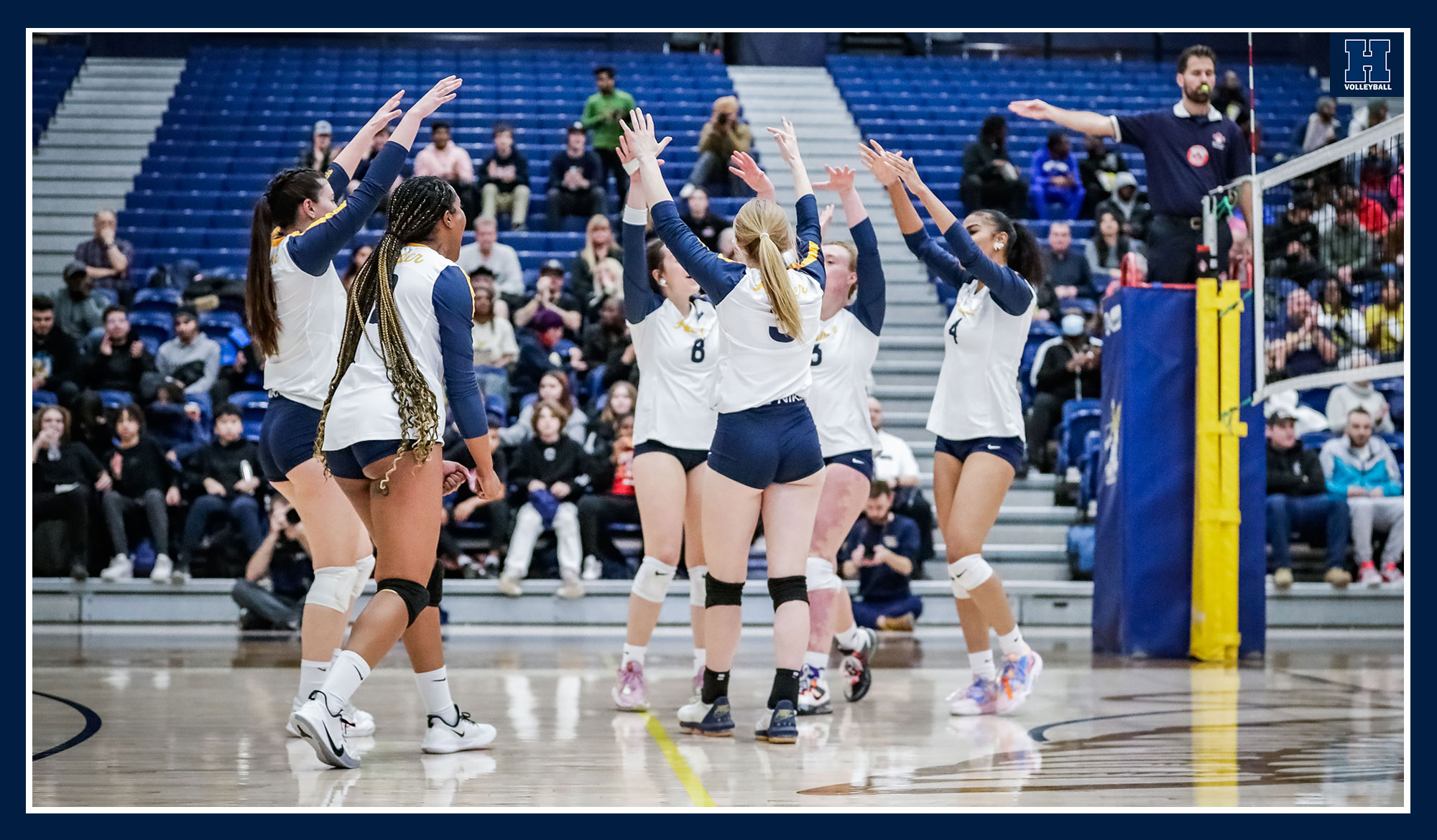 Women's volleyball celebrating a point
