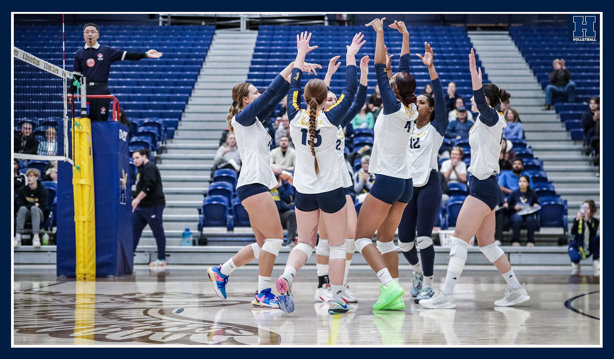 Women's volleyball celebrating a point